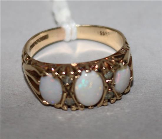 A 9ct gold, three stone white opal and diamond chip set dress ring, size O.